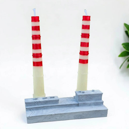 Aureal Aromatics Poolbeg candle set featuring two red and white striped beeswax towers on a grey stone-effect base.