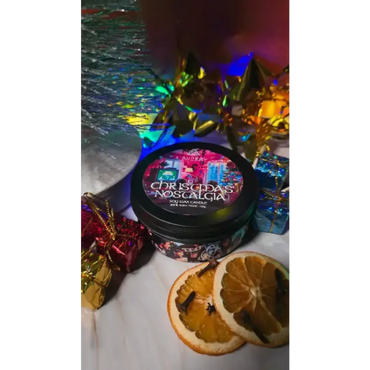 Christmas Nostalgia candle tin with dried orange slices and small wrapped gifts