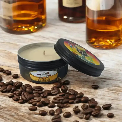 Black tin candle with a coffee cup label among coffee beans, bottles behind