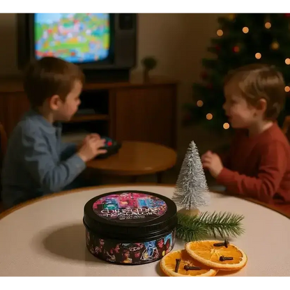 Christmas Nostalgia candle on a table with dried orange slices, two children by a TV behind
