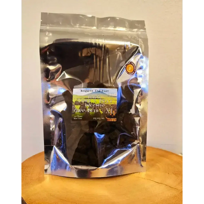 Silver resealable bag of Irish Turf Peat Incense Wee Bits on a wooden board