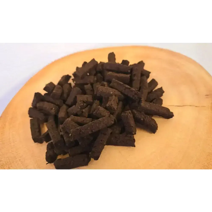 Large pile of Irish turf incense Wee Bits on a wood slice