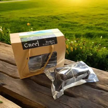 Creel Basket Set box and a foil pack of turf on a wooden table outdoors