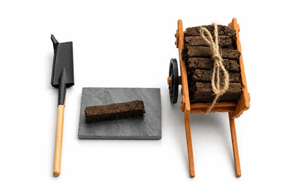 Sleán spade, a turf sod on a slate and the turf cart loaded with tied turf sods