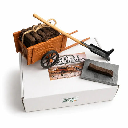 Turf cart, sleán and a turf sod on a slate on top of the Irish Turf Cart and Sleán box