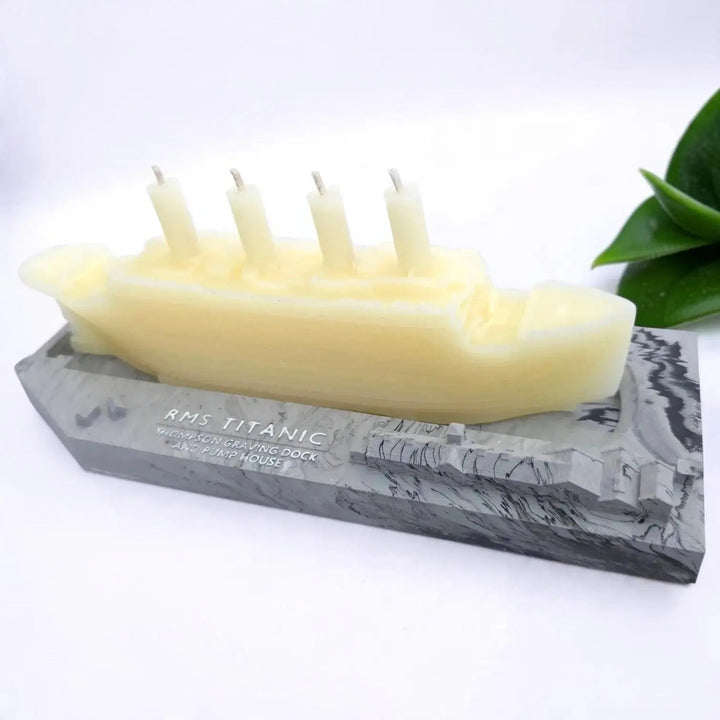 Cream beeswax Titanic candle with four funnel wicks on a grey RMS Titanic base