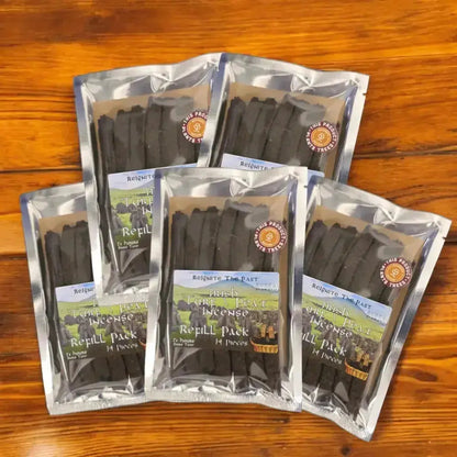 Five Irish Turf Peat Incense Refill Packs in silver foil bags on a wooden table